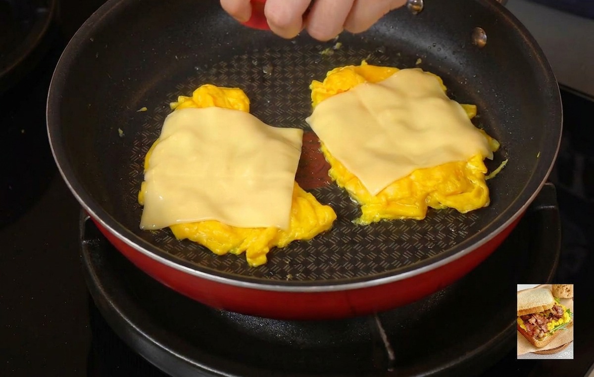 チーズを溶かすためにフライパンに赤い蓋をかぶせている様子