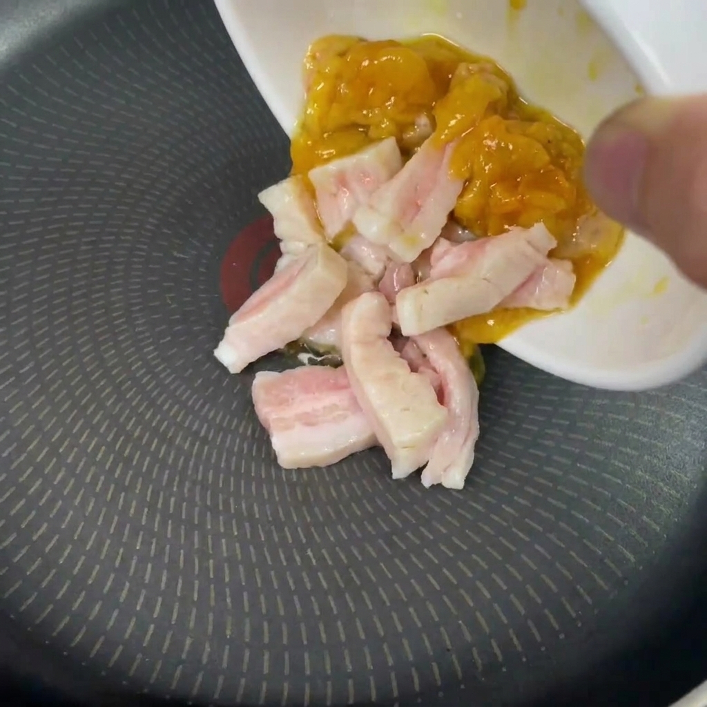 フライパンに鶏脂と豚の背脂を入れている様子。