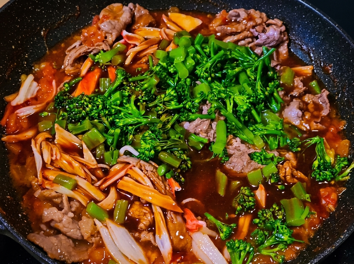 フライパンの具材にソースを注いでいる様子