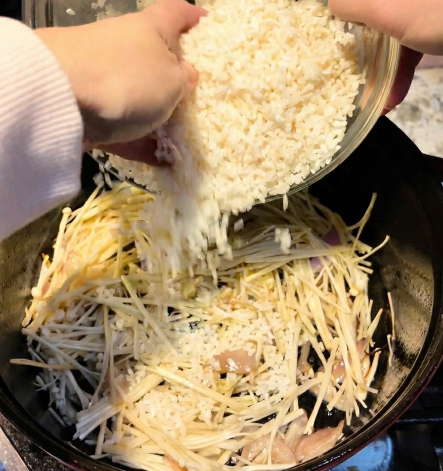 えのきが入った鍋に、洗ったお米2カップを投入している様子。