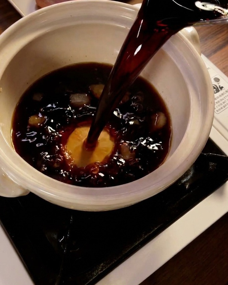 鍋に醤油を注ぎ、ソースを煮詰めている様子