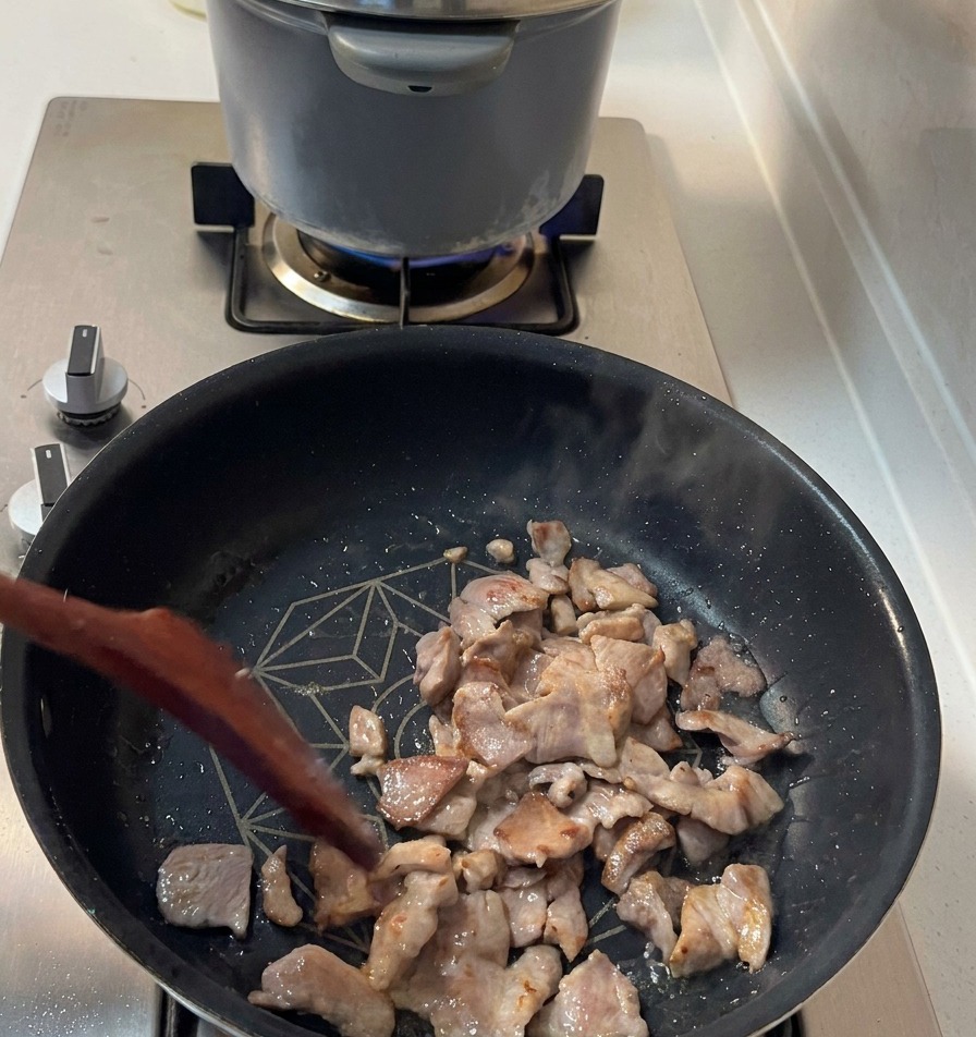 フライパンの中で焼き色がつき、香ばしそうな豚肉のアップ。