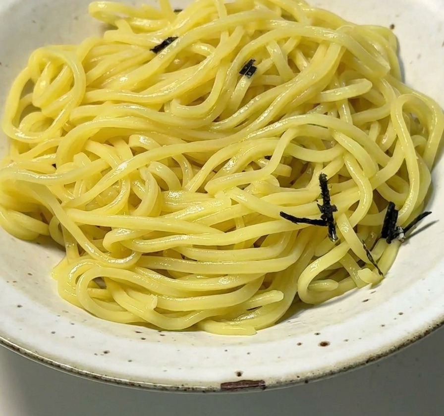 盛り付けた麺の上に、刻み海苔をたっぷりと散らしている様子。