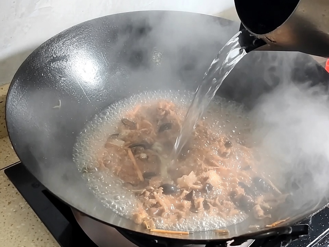 鍋に水を加えてスープを煮込んでいる様子。
