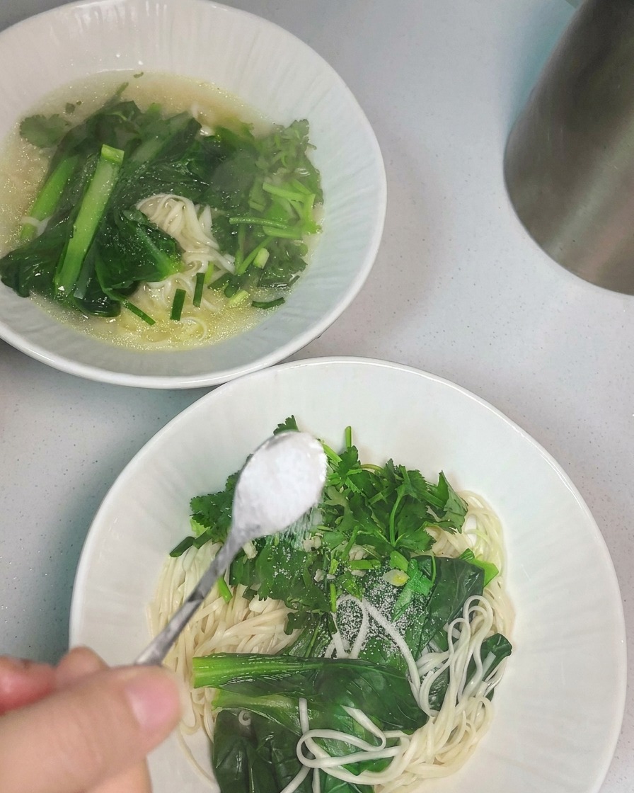 熱いチキンスープをお玉で器に注いでいる様子。