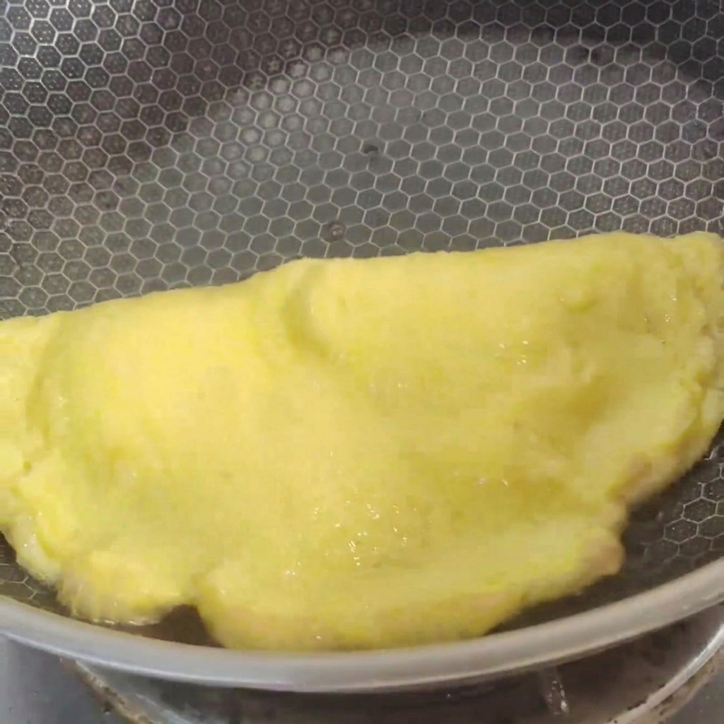 中華鍋で豚肉と筍を一緒に炒めている様子。