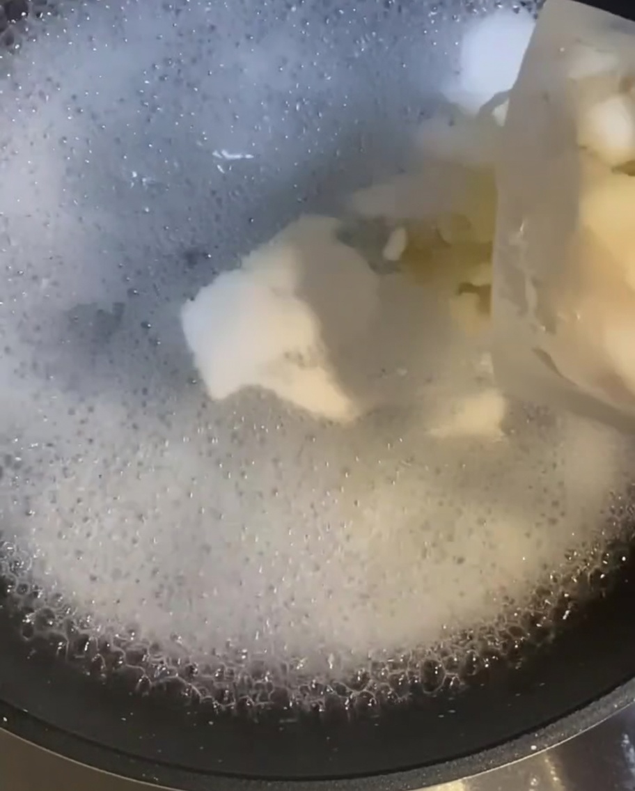沸騰した湯に入れられ、加熱されていく生のむきエビ。