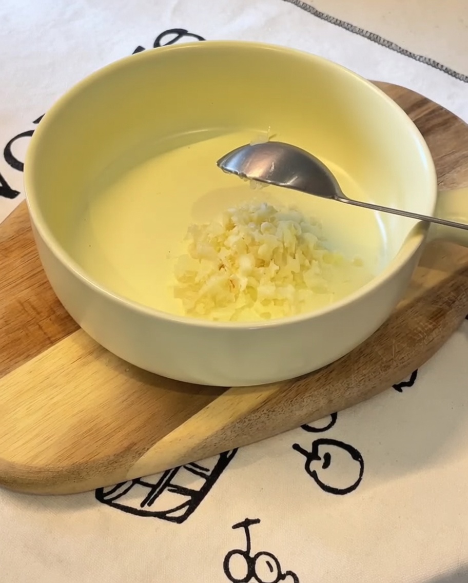 黄色いボウルに入った、おろしにんにく、ネギ、マヨネーズ、卵黄、ラーメンスープの素。