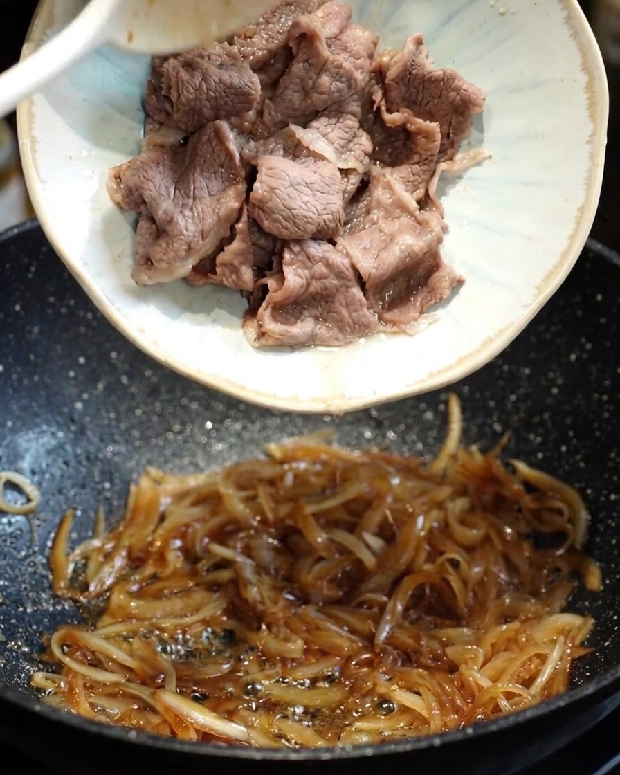 醤油や蜂蜜を合わせた照り焼きダレをフライパンに回し入れ、煮詰めている様子。