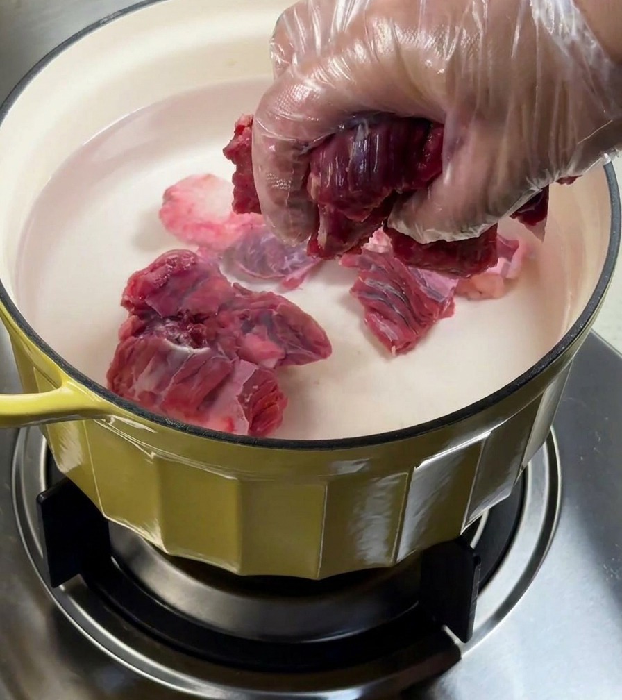 香味野菜を入れた鍋の湯で牛バラ肉を下茹でしている様子。