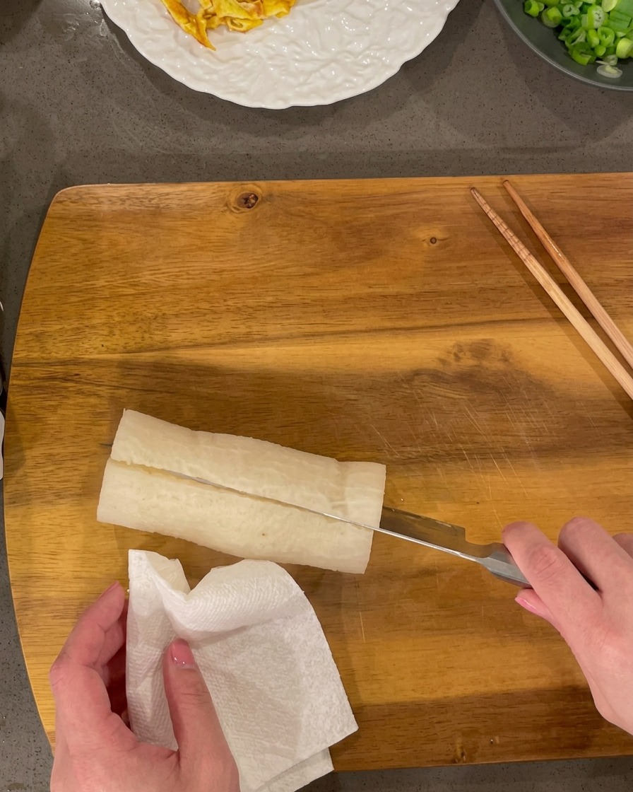 煮上がった大根を一口サイズに切り分けている様子。