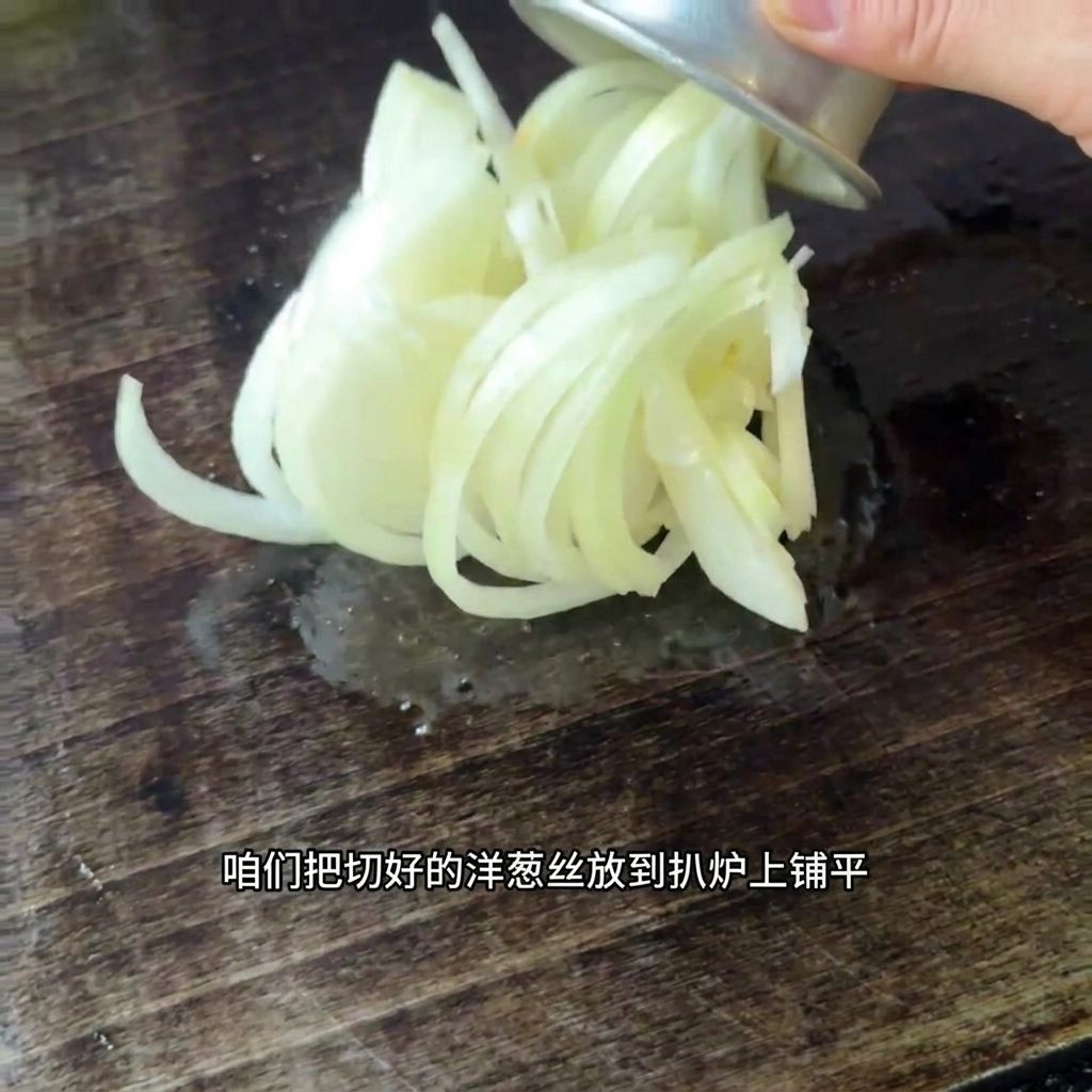 熱した鉄板の上に広げられた、スライスしたての玉ねぎ。