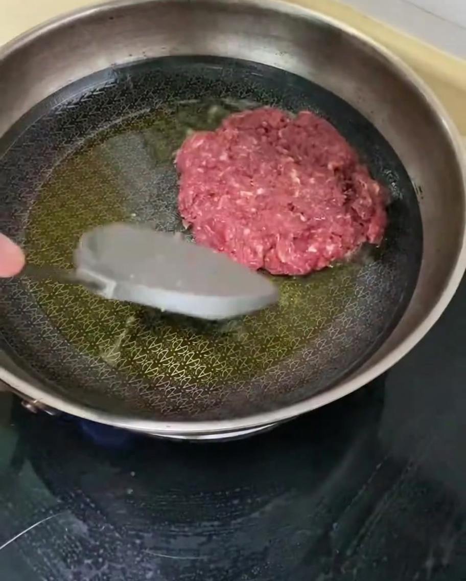熱したフライパンでビーフパティを焼いている様子。