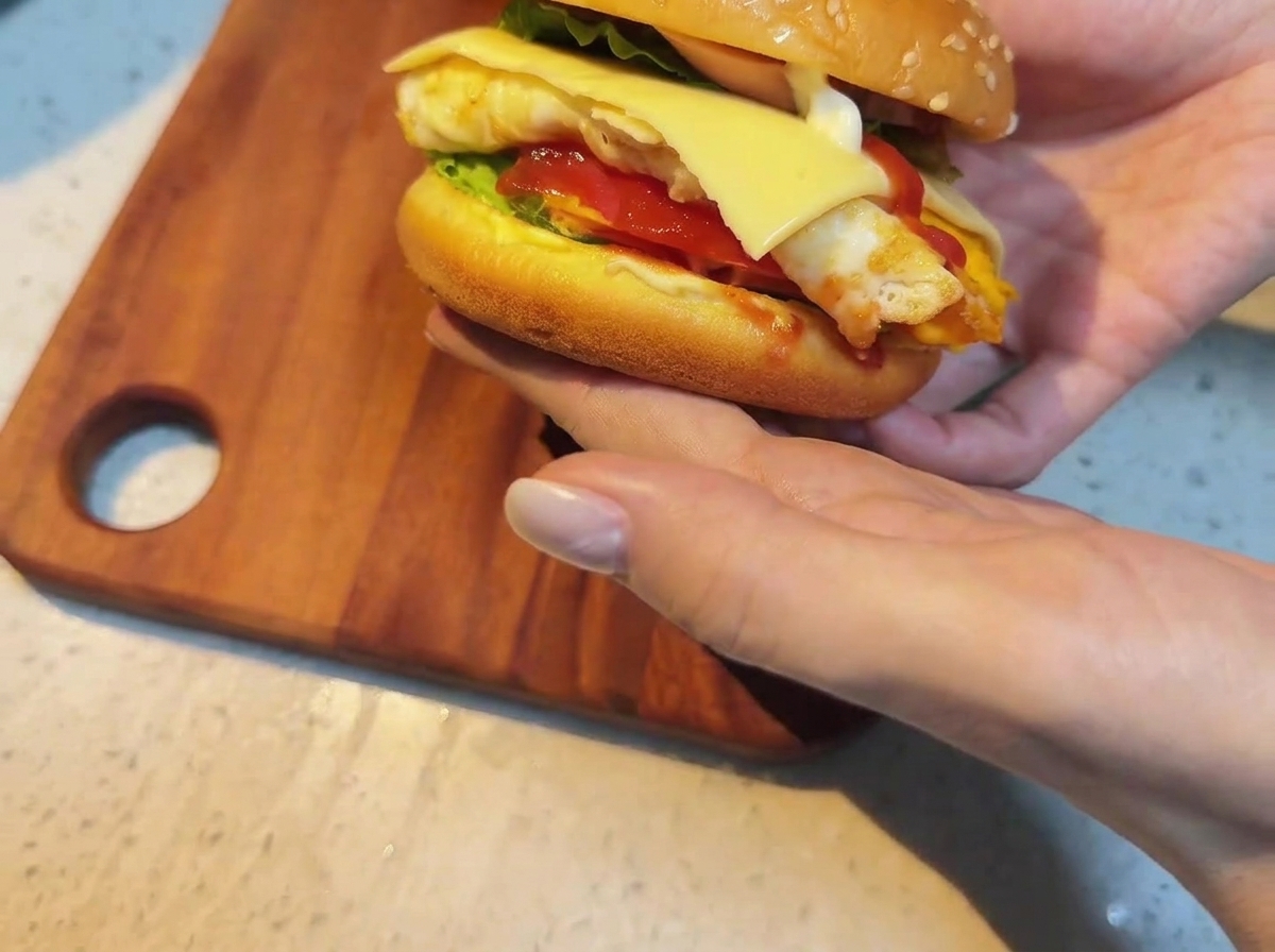 具材の上にスライスチーズをのせる様子。