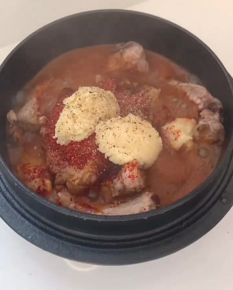 味付けされた豚肉の上に、刻んだ玉ねぎと長ねぎをのせている様子。