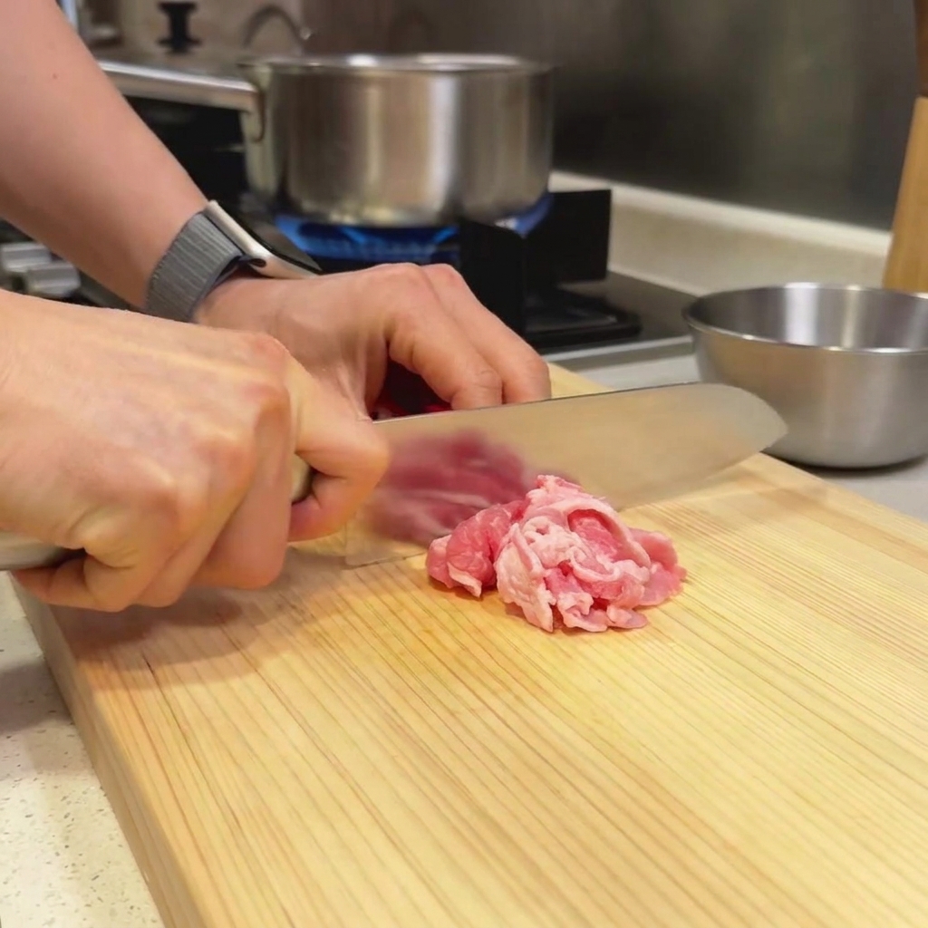 木のまな板の上で下準備された牛薄切り肉