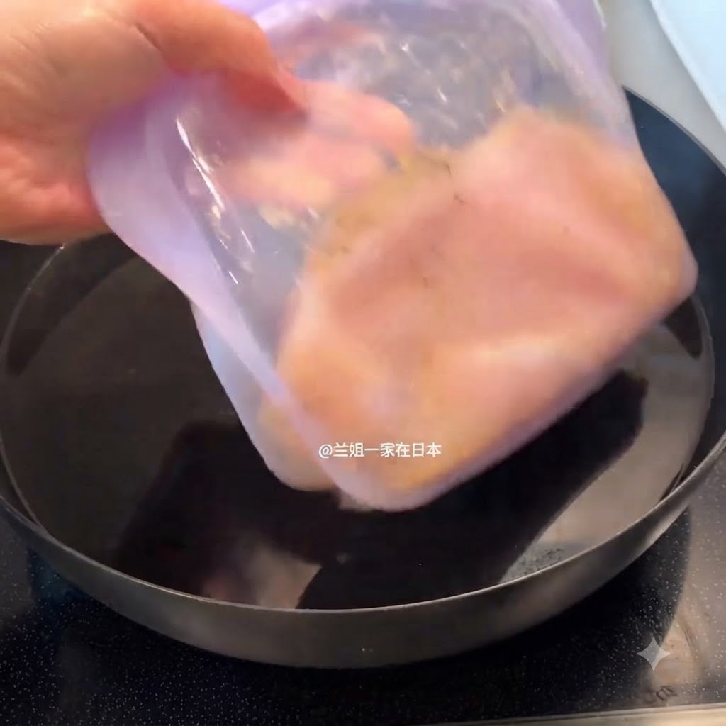 下味をつけた鶏肉を入れた密閉容器を、水を入れた鍋に沈めている様子